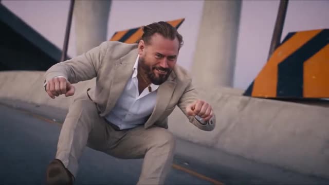 Crazy Frog AI clip opening: squatting low on an invisible moped down a concrete overpass